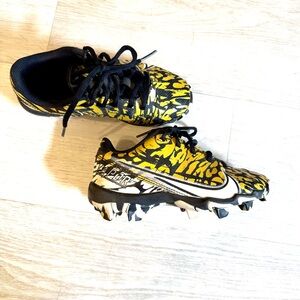 {Nike} gold and black cleats